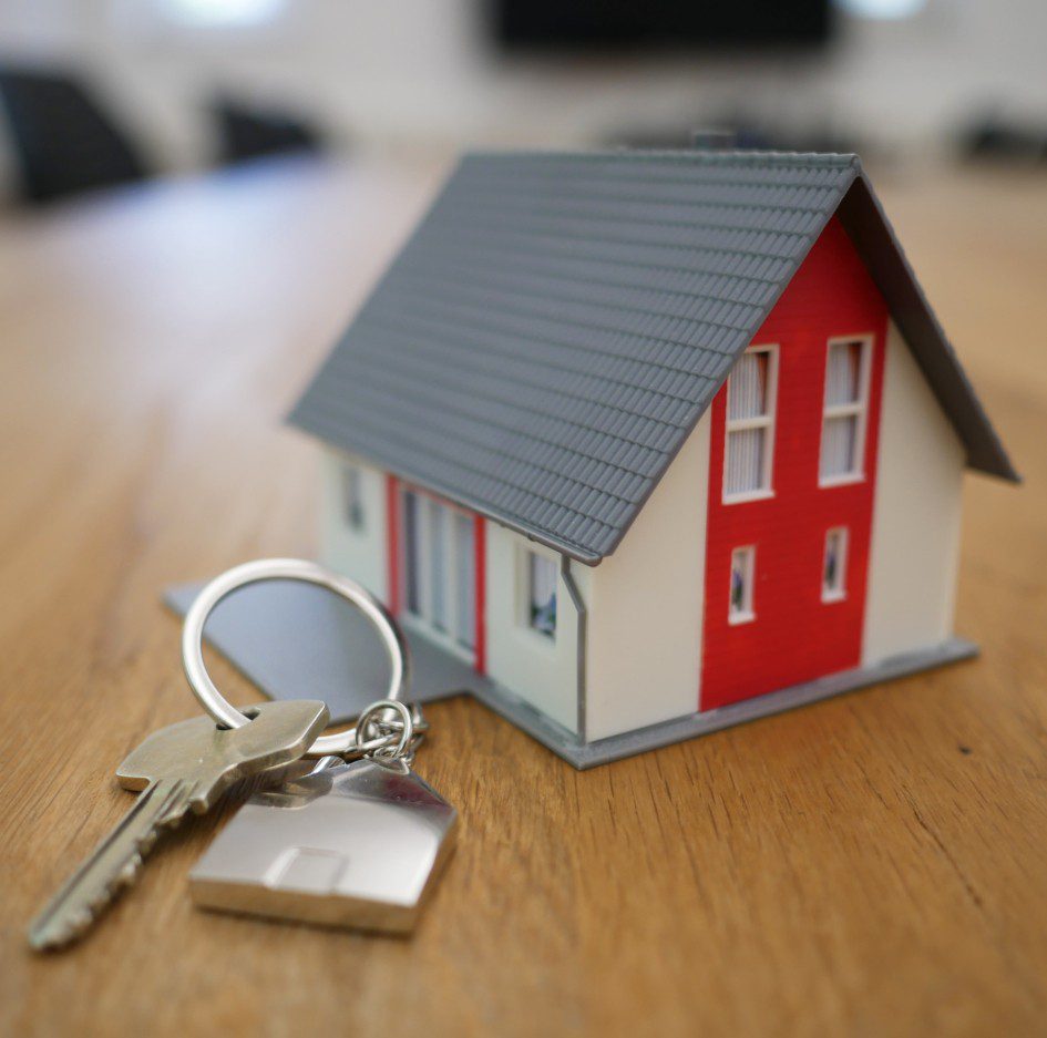 house keys and miniature model of a house